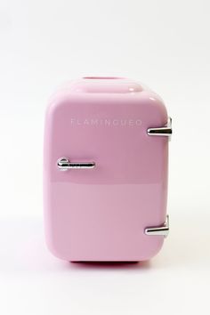 a pink toaster sitting on top of a white table