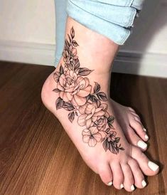 a woman's foot with flowers on it