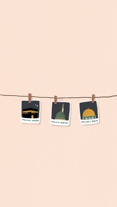 three pictures hanging on a line with clothes pins and magnets attached to the string