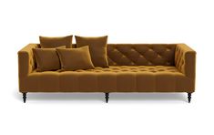 a brown couch with four pillows on the back and one pillow sitting on top of it