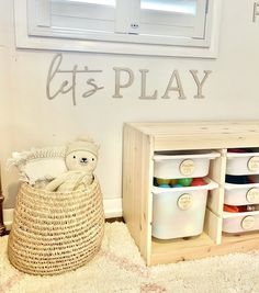 a teddy bear sitting in a basket next to some baskets and toys on the floor