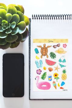 a notepad with stickers on it next to a phone and succulent plant