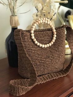 "\"Elevate your summer style with our Women's Raffia Crossbody Bag! Crafted from natural straw and featuring a round wooden handle, it's a perfect accessory for city outings. Upgrade your seasonal fashion now! 🌞👜\"" Brown Crochet Bag With Handles For Beach Season, Summer Brown Pouch Straw Bag, Brown Crochet Bag For Everyday Beach Season, Eco-friendly Crochet Bucket Bag With Adjustable Strap, Everyday Brown Crochet Bag For Beach Season, Eco-friendly Bag With Adjustable Strap And Natural Fiber, Eco-friendly Bags With Adjustable Strap, Eco-friendly Beige Beach Bag With Round Handle, Eco-friendly Natural Fiber Bag With Adjustable Strap