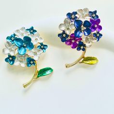 When summer arrives, wear this elegant endless summer Hydrangea Flower Brooch. Hydrangea represents gratitude and grace. Add a touch of beauty and sophistication to any outfit with this versatile accessory. Perfect for dresses, coats, short sleeves, hats, bags, and shawls. Elevate your style with this stunning floral brooch pin. Dimensions: 3.5cm*5cm Materials: Alloy, rhinestone Flower-shaped Brooch For Spring Wedding, Flower Shaped Brooch For Spring Wedding, Flower Shaped Wedding Brooch For Spring, Blue Flower Brooch With Floral Decoration, Blue Flower Brooches With Flower Decoration, Spring Flower Brooches With Flower Decoration, Summer Hydrangea, Dresses Coats, Endless Summer Hydrangea