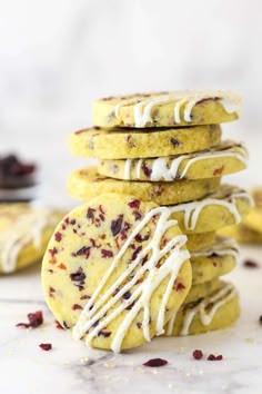 a stack of cookies with white icing and cranberries