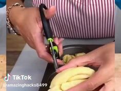 a person cutting some food with a pair of scissors