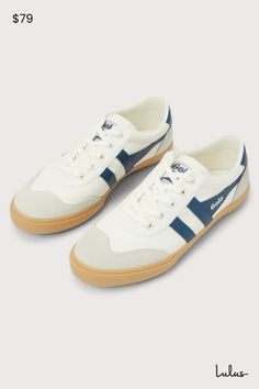 We're ready to hit the town (and court) in the GOLA Badminton Off White and Baltic Color Block Suede Sneakers! Sturdy woven canvas and genuine suede leather come together in hues of white, light grey, and dark blue, to form a rounded toe and a classic lace-up vamp. Low-cut collar, with logo tag at the tongue and outstep, completes the retro-style look! 1. 15" rubber heel. Lightly cushioned insole. Rubber sole has nonskid markings. Genuine suede leather accents. Balance man made materials. Import White Low-top Sneakers With Leather Trim, White Sporty Sneakers With Leather Trim, Sporty White Sneakers With Leather Trim, White Leather Trim Sporty Sneakers, Casual Low-top Sneakers With Leather Trim, Sporty Lace-up Sneakers With Leather Trim, Gola Badminton, Lulu Fashion, Leather Accents