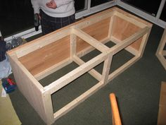 a person standing in front of a wooden box