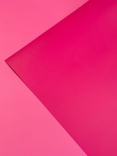 a close up of a pink paper on a pink background with space for the text