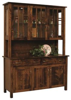 a wooden hutch with glass doors and plants on it's top shelf, against a white background