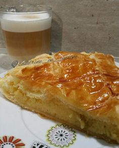 a piece of pie sitting on top of a plate next to a glass of beer