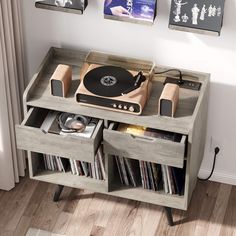 a record player is sitting on top of a table with records and cds in it