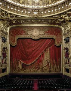 an ornately decorated stage with red curtains