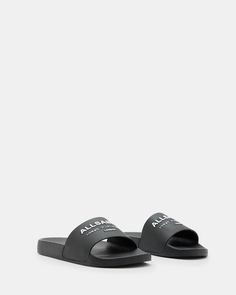 Moulded from rubber, our Underground Slides are essential for chilled out summer styling. Our iconic signature features across the strap. From London to Tokyo - that's the bestselling Underground logo. An ideal casual staple for hot days, or even team them with matching socks - it's a look. If you are between sizes, we recommend sizing up Slides Round toe Moulded silhouette Slip on AllSaints Underground logo Casual Black Slides With Logo, Black Logo Slides For Summer, Black Slides With Logo For Summer, Sporty Slides For Spring Leisure, Modern Slides For Spring Streetwear, Casual Beach Slides, Summer Beach Slides With Logo, Summer Sports Slides, Athleisure Sports Slides For Summer