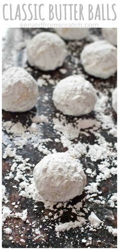 several balls of powdered sugar on top of a baking sheet with the words classic butter balls