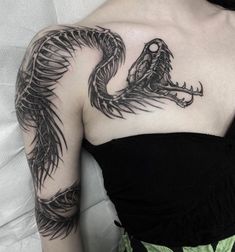 a woman with a dragon tattoo on her shoulder