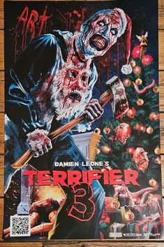 a poster for the movie termiffer 3 is displayed on a wooden table with christmas decorations