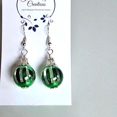 Green Christmas Light Bulb Crystal Dangle Pierced Earrings With Silver Toned Ear Wires Light And Airy Super Cute Christmas Holiday New Years Party Elegant Holiday Jewelry With Matching Earrings, Elegant Holiday Dangle Earrings, Adjustable Silver Christmas Earrings, Elegant Green Holiday Earrings, Holiday Silver Jewelry With Ear Wire, Silver Earrings For Holiday Parties, Holiday Green Drop Earrings, Elegant Silver Christmas Earrings, Elegant Silver Earrings For Christmas