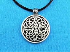 "Welcome! This listing is for a circular necklace medallion featuring a simple Quaternary Tri Celtic knot work that was handmade and cast by my Husband and I. This is made with silver pewter, and is 100% lead-free! Larger version of this pendant: https://www.etsy.com/listing/590459642/quaternary-tri-celtic-knotwork-pendant?ref=shop_home_active_1 It measures: 1 1/8 inches in diameter (1 1/2 inches tall including the necklace hanger / bail) , or 29 mm in diameter (39 mm including the necklace bail Adjustable Hand Cast Round Pendant Necklaces, Adjustable Nickel Free Medallion Necklace, Nickel Free Round Pewter Jewelry, Silver Medallion Necklace Hand Cast, Hand Cast Silver Medallion Necklace, Adjustable Silver Pendant Medallion Necklace, Silver Adjustable Medallion Necklace With Round Pendant, Adjustable Silver Medallion Pendant Necklace, Silver Medallion Hand Cast Necklace