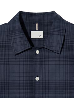 The shirt is made of lightweight, breathable, and soft cotton fabric in plaid pattern designed by the brand. The shirt features wearable relaxed fit, single collar without neckband, and pleats on the front shoulder. The interlining on front panel and placket minimizes fabric twist and makes the shirt more durable.- Single collar- Signature logo embroidery- Back pleats- Logo engraved buttons Plaid Shirt With Spread Collar And Placket, Plaid Camp Collar Tops With Relaxed Fit, Collared Plaid Shirt With Placket, Plaid Collared Shirt With Placket, Plaid Collared Shirt, Plaid Shirts, Plaid Shirt Men, Korean Brands, Mens Linen