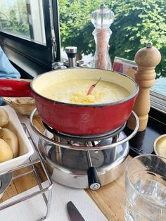 a bowl of soup sitting on top of a table next to other bowls and utensils