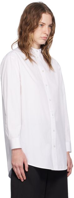 Cotton poplin shirt. · Band collar · Button closure · Logo embroidered at front · Shirttail hem · Dropped shoulders · Single-button barrel cuffs · Box pleat at back yoke · Mother-of-pearl hardware Supplier color: Optic white Classic Poplin Blouse With Button Cuffs, Daywear Poplin Blouse With Button Cuffs, Daywear Poplin Tops With Button Closure, Daywear Tops With Button Closure, Poplin Tops With Button Closure For Daywear, Poplin Shirt With Button Closure For Daywear, Wednesday Shirt, Cotton Poplin Shirt, Band Collar