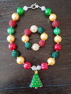 "Christmas Inspired Christmas Tree Children's Chunky Bubblegum Bead Necklace & Bracelet Set/ Holidays This very cute Christmas Tree Necklace & Bracelet Set is a perfect addition to any holiday outfit and the holiday season. The Necklace is made up primarily of 20mm beads in shades of red, green and yellow gold. The necklace measures approximately 11\" when toggled around neck including the Christmas Tree pendant. The Bracelet is an elastic bracelet, doubled up for extra strength. The Nec Christmas Tree Necklace, Cute Christmas Tree, Grinch Stole Christmas, Backpack Charm, Bubblegum Beads, Tree Necklace, Holiday Outfit, Tree Pendant, Elastic Bracelet