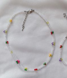 a white beaded necklace with multicolored beads