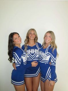 three cheerleaders are posing for the camera