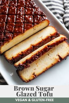 slices of meatloaf on a white plate with black and white striped napkins