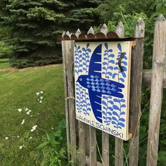 a wooden fence with a blue bird painted on it