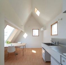 an empty kitchen and dining room with skylights in the roof dormer window area