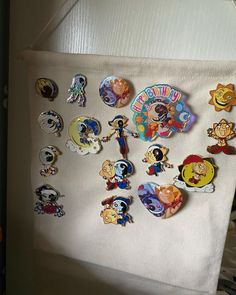 there are many cartoon pins on the wall