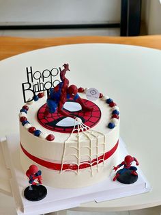 a spiderman themed birthday cake on a table