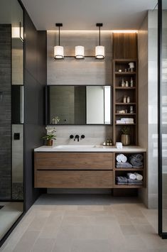 a modern bathroom with two sinks and open shelving