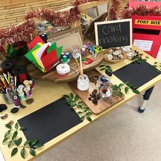 an assortment of crafting supplies on a table with writing paper and chalkboard signs