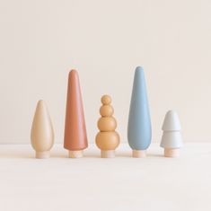 small wooden toys are lined up in a row