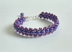 a purple beaded bracelet with silver beads