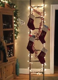 a ladder decorated with stockings and christmas lights