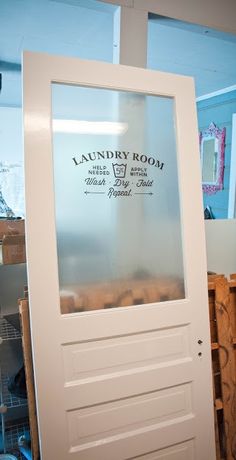 an image of a door with the name laundry room on it's glass panel