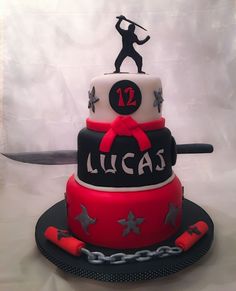 a red and black cake with a man holding a baseball bat on top of it