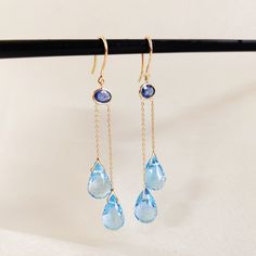 These stunning drop earrings are set in 14K Solid Yellow Gold with Natural Blue Sapphire and Swiss Blue Topaz with utmost precision. It is an unique gemstone earring pair for nearly every occasion and is completely hassle-free jewelry. 🔷 ABOUT GEMSTONE: Blue Sapphire is a breathtaking gemstone, renowned for its deep, celestial blue color that symbolizes wisdom, loyalty, and nobility.  ♥ Zodiac: Blue Sapphire is commonly associated with the zodiac signs of Virgo and Libra, enhancing their analyt Sapphire Gem, Handmade Jewelry Box, Bezel Earrings, Blue Topaz Earrings, Solid Gold Earrings, Topaz Earrings, Swiss Blue Topaz, Natural Blue Sapphire, December Birthstone