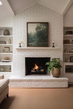 a living room with a white brick fireplace