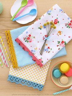 the table is set with colorful napkins, plates and utensils on it