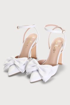 Grab a chic addition like the Lulus Penson White Bow Pointed-Toe Ankle Strap Pumps to elevate anything from an evening ensemble to your special day look! Smooth faux leather shapes a single sole silhouette and a classic pointed-toe upper, adorned with an oversized bow detail. Two long straps sprout from the sides and secure around the ankle with a shiny gold buckle, all atop a trendy blade heel. 4" wrapped blade heel. Cushioned insole. Rubber sole has nonskid markings. All Man Made Materials. Im Prom Heels Pearl, White High Heels With Bows, Bow Heels White, Bridal Low Heels, White Heels With Ribbon, White Shoes With Bow, White Closed Heels, Aesthetic White Heels, White Heels Closed Toe