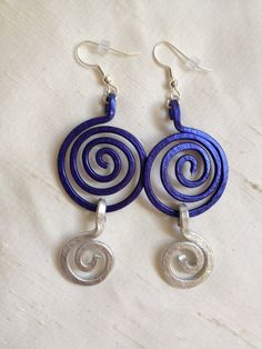 pair of earrings with spiral design on white background