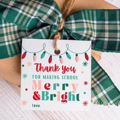 a thank you for making school merry and bright tag hanging from a present wrapped in twine