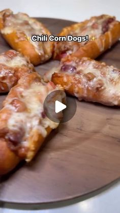 several pieces of pizza sitting on top of a wooden plate