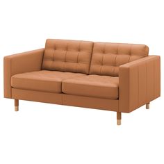 a tan leather couch sitting on top of a white floor next to a wooden frame