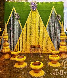 an outdoor stage set up with yellow flowers and greenery